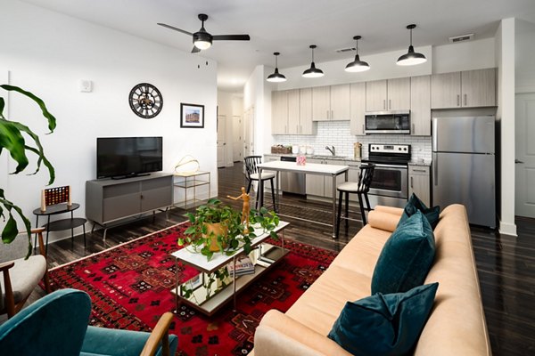 Spacious living room with contemporary decor in The Oliver Apartments