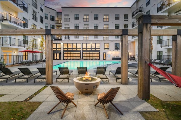 Cozy outdoor fire pit area at The Oliver Apartments, perfect for social gatherings and relaxation