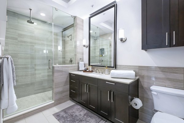 Bathroom featuring elegant fixtures and bright lighting in Flatiron Domain Apartments