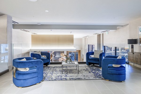 Clubhouse lobby featuring modern design and stylish seating at Flatiron Domain Apartments