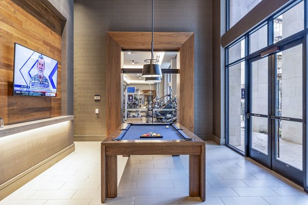 Clubhouse game area with billiards and seating at Flatiron Domain Apartments