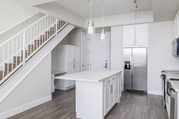 Contemporary kitchen featuring stainless steel appliances at Flatiron Domain Apartments