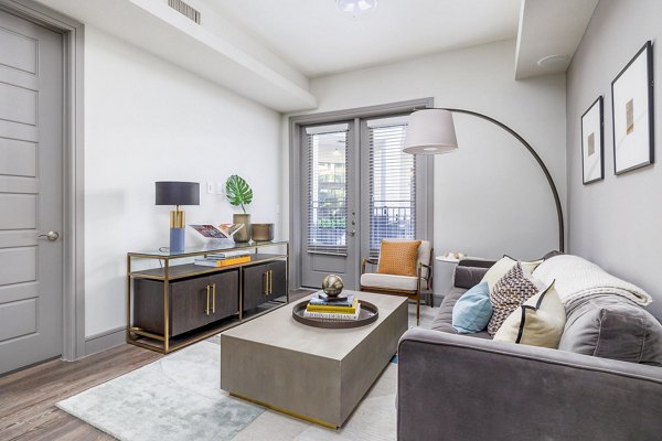 Spacious living room with contemporary furnishings at Flatiron Domain Apartments, showcasing luxury living spaces in a Greystar community