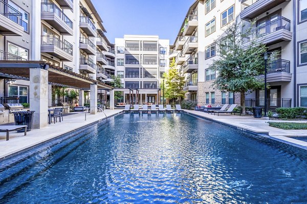 Resort-style pool with sun loungers at Flatiron Domain Apartments