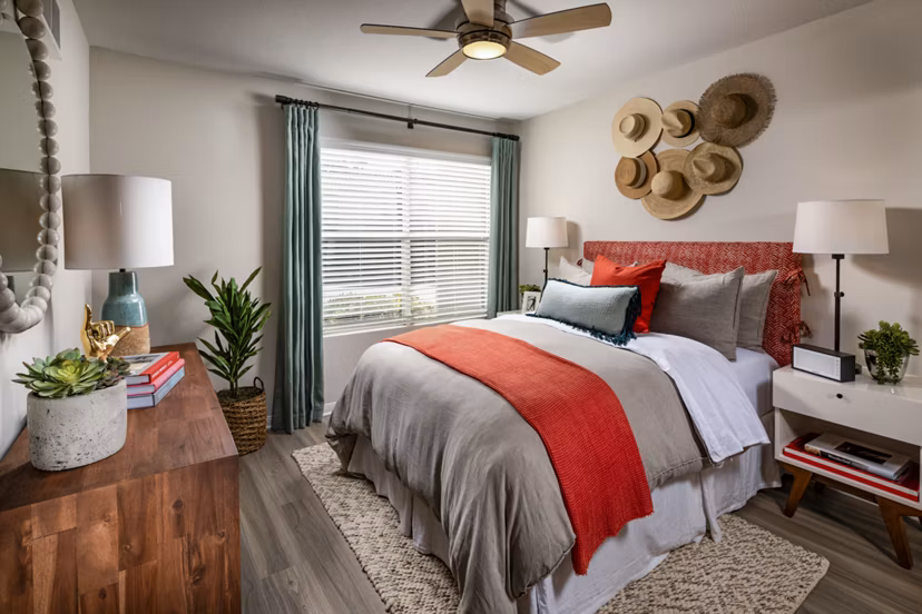 Bedroom with ocean-themed decor at Seacrest Apartment Homes, featuring plush bedding and large windows for natural light