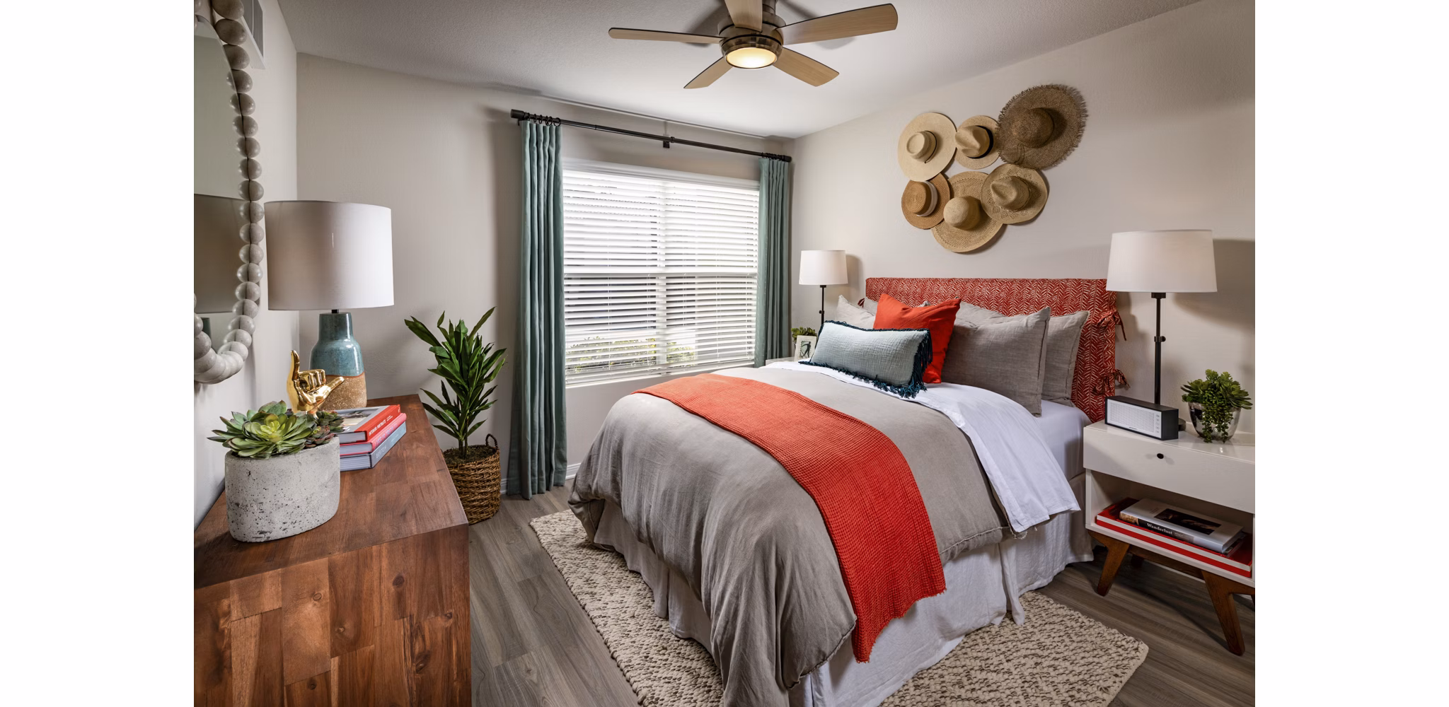 Bedroom with ocean-themed decor at Seacrest Apartment Homes, featuring plush bedding and large windows for natural light