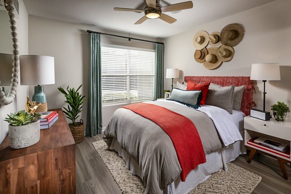 Bedroom with ocean-themed decor at Seacrest Apartment Homes, featuring plush bedding and large windows for natural light