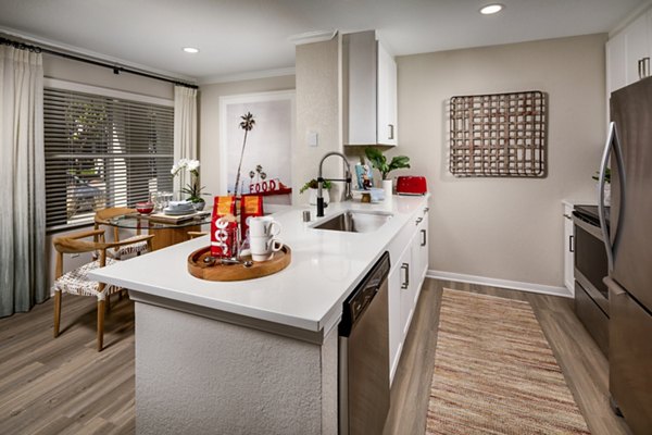 Sleek kitchen with stainless steel appliances and modern fixtures at Seacrest Apartment Homes