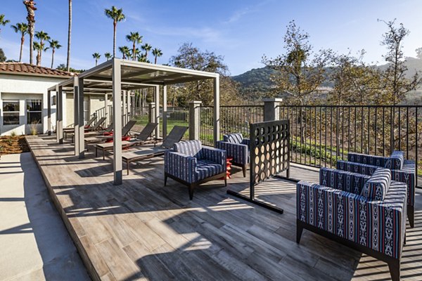 Outdoor entertainment area with lounges and games at Seacrest Apartment Homes