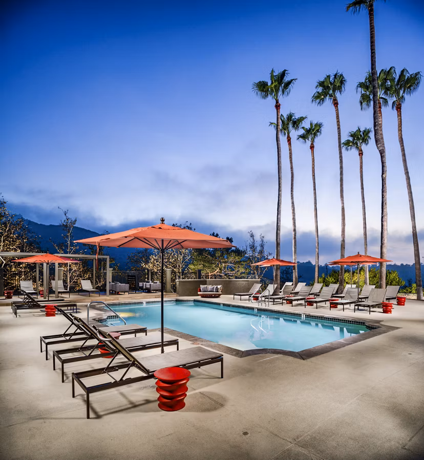 Inviting outdoor pool area with lounge chairs at Seacrest Apartment Homes, offering relaxation and leisure for residents