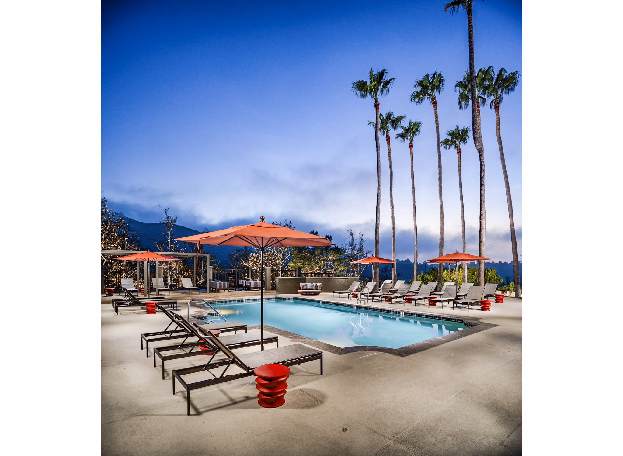 Inviting outdoor pool area with lounge chairs at Seacrest Apartment Homes, offering relaxation and leisure for residents