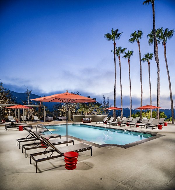 Inviting outdoor pool area with lounge chairs at Seacrest Apartment Homes, offering relaxation and leisure for residents