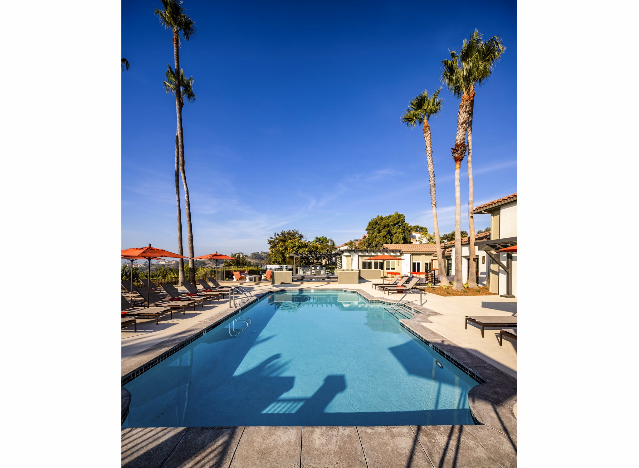 Luxury poolside retreat at Seacrest Apartment Homes, featuring sleek lounge areas and crystal-clear waters for ultimate relaxation and leisure