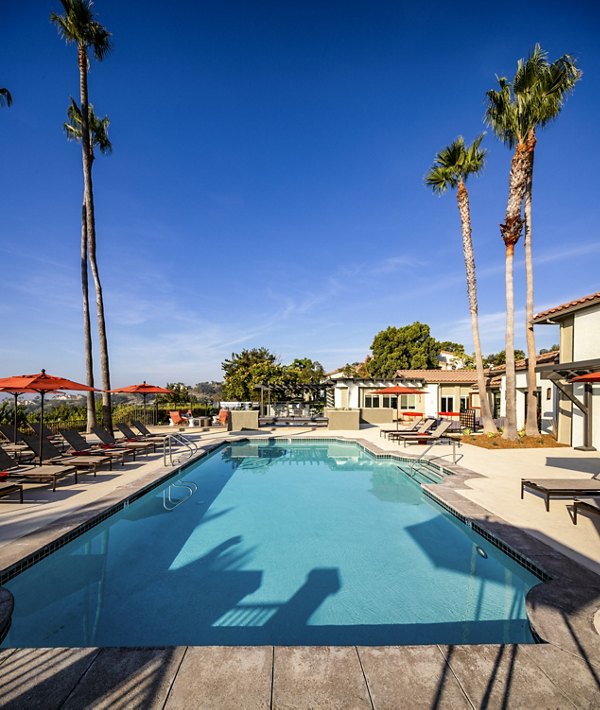 Luxury poolside retreat at Seacrest Apartment Homes, featuring sleek lounge areas and crystal-clear waters for ultimate relaxation and leisure