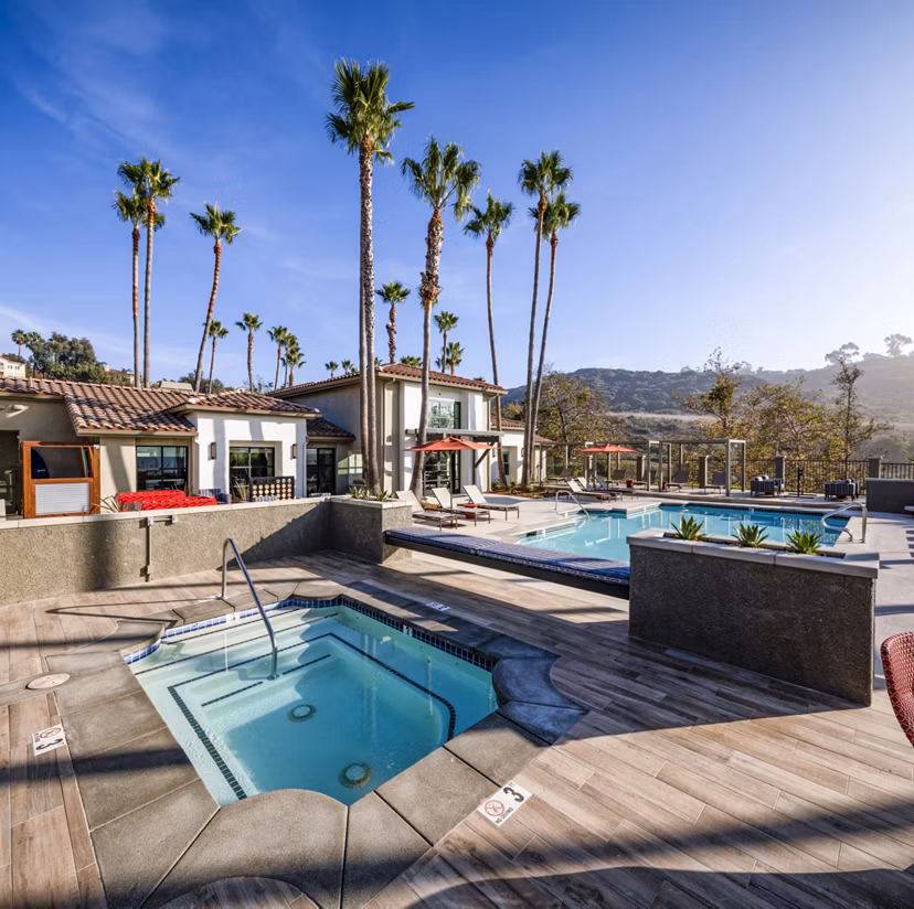 Resort-style pool with lounging area at Seacrest Apartment Homes