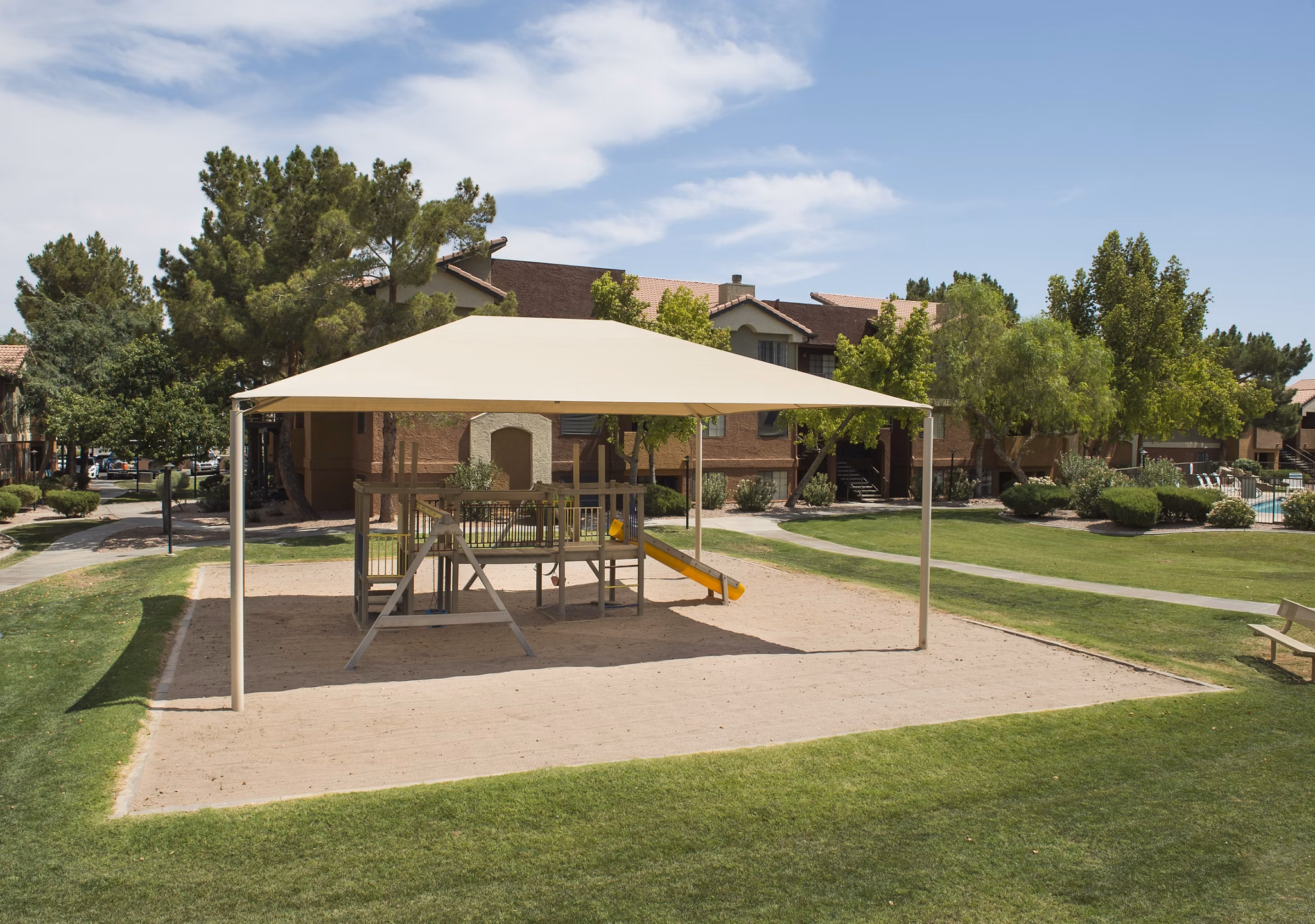 Children's playground with slides and swings at Avana Gilbert luxury apartments, perfect for family-friendly outdoor activities