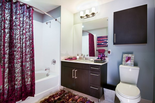 Bathroom featuring modern fixtures and marble countertops in Estuary Phase II Apartments