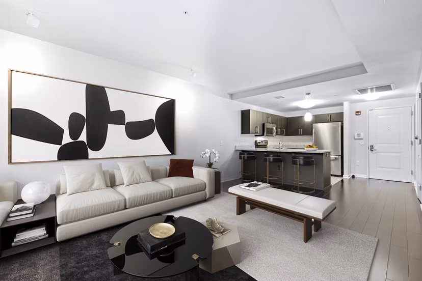 Modern living room with sleek furniture and large windows at Estuary Phase II Apartments