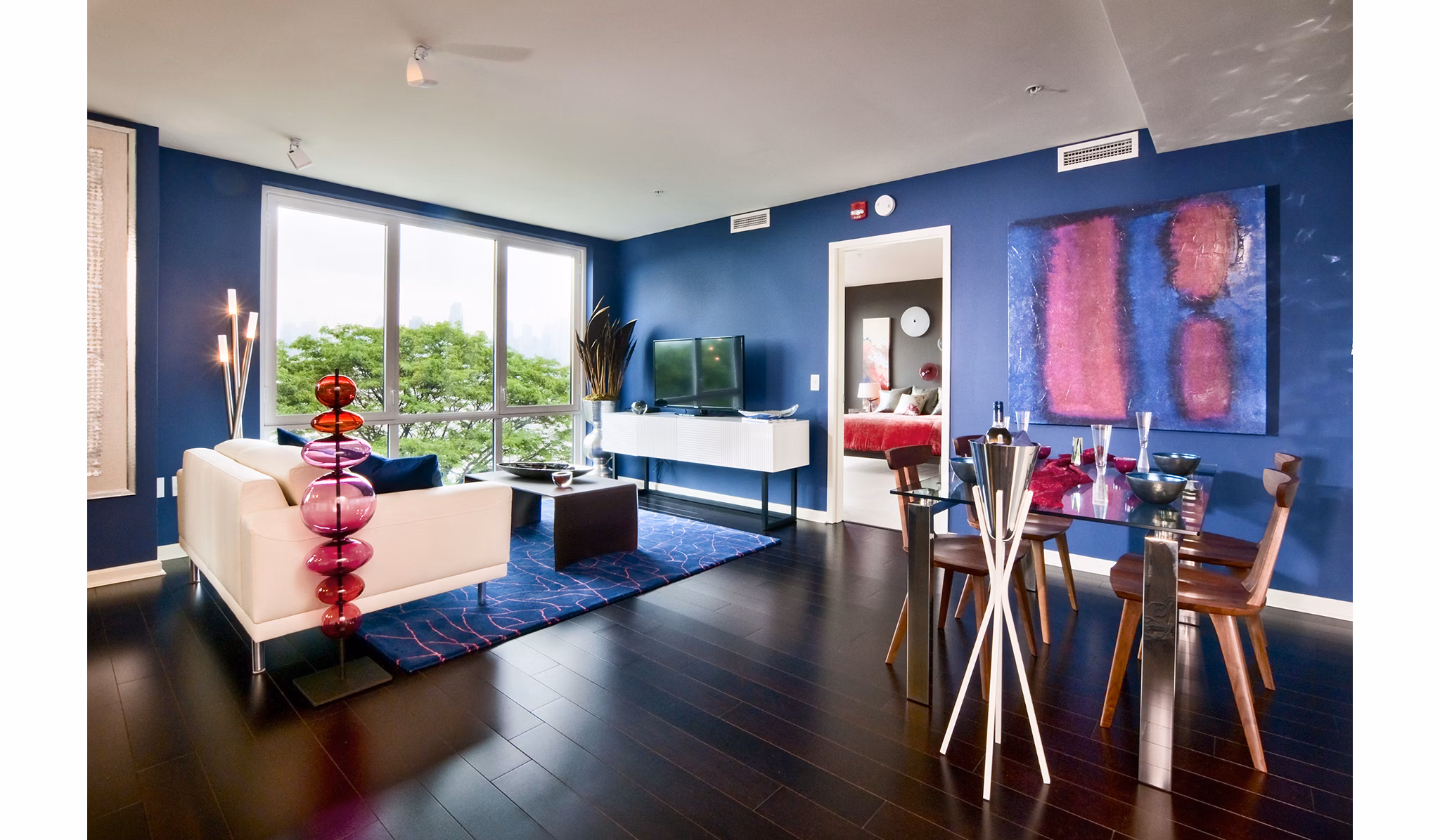 Modern living room with sleek furniture and large windows at Estuary Phase II Apartments