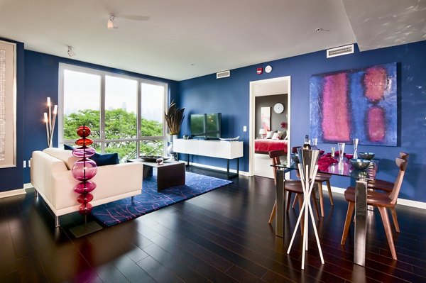 Modern living room with sleek furniture and large windows at Estuary Phase II Apartments