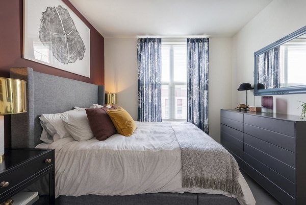 Modern bedroom with stylish furnishings in West of Chestnut Apartments