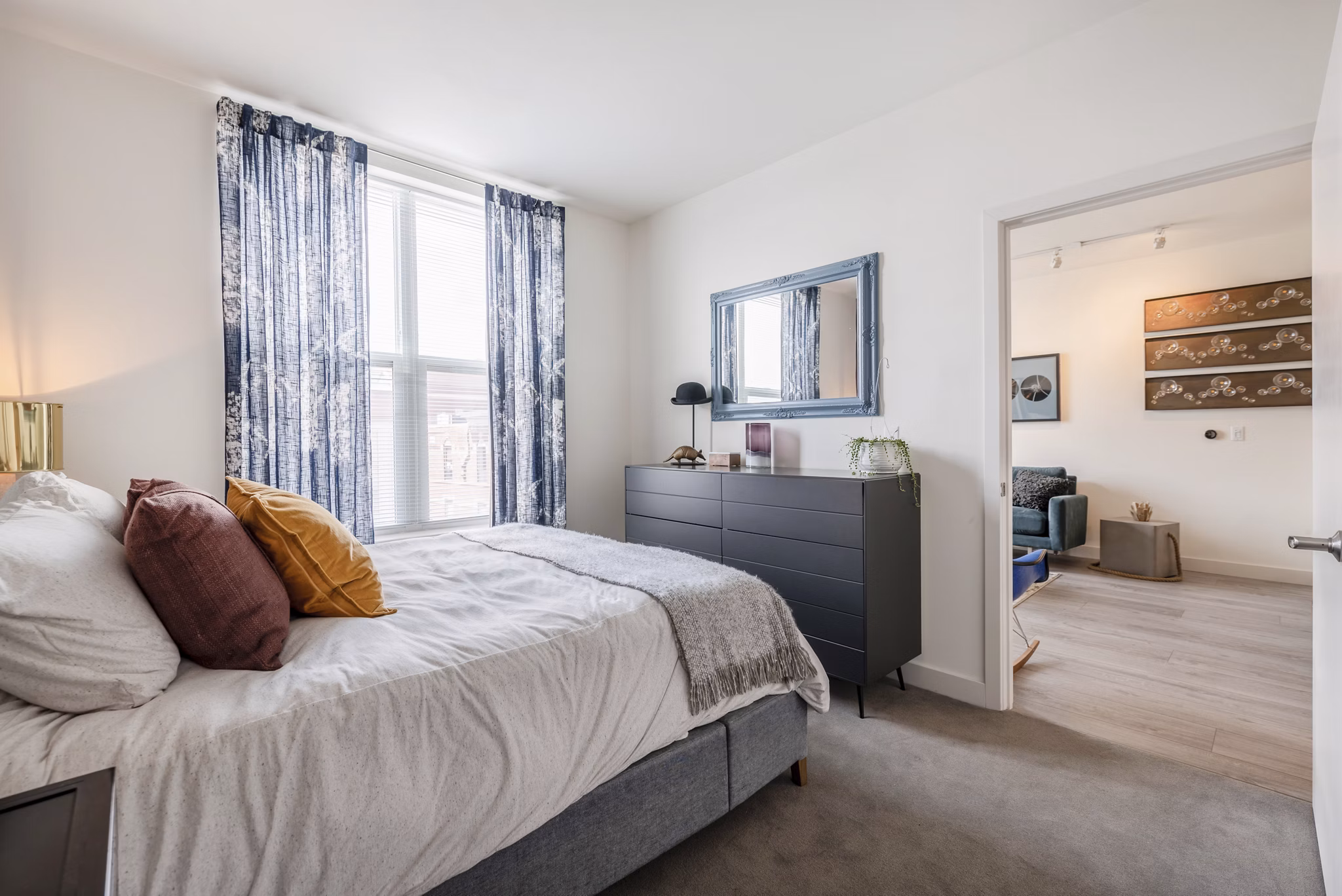 Modern bedroom with sleek furnishings at West of Chestnut Apartments