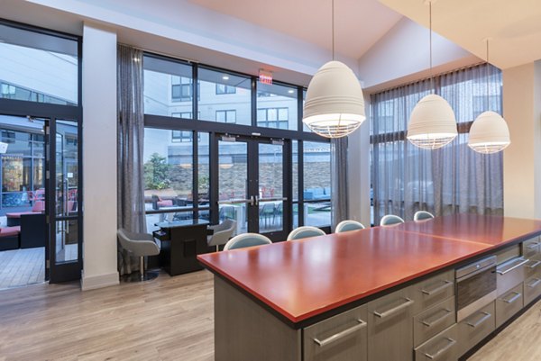 Modern clubhouse featuring lounge seating and pool table at West of Chestnut Apartments luxury community