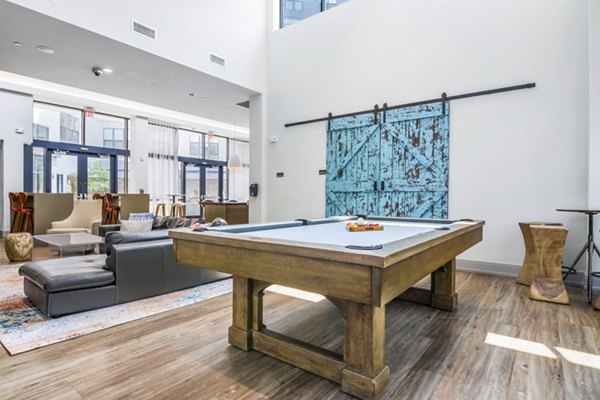 Clubhouse game room featuring pool table and modern decor at West of Chestnut Apartments