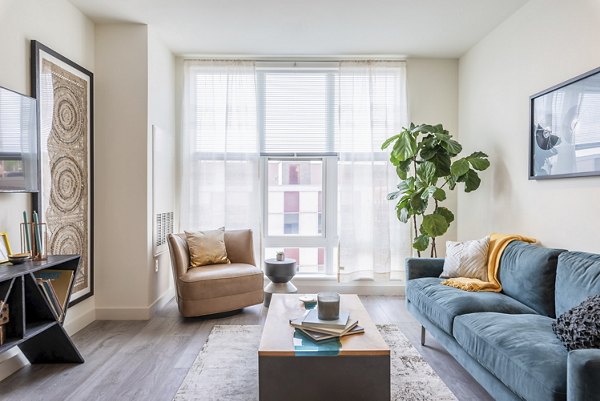 Contemporary living room with modern furnishings at West of Chestnut Apartments, Quincy