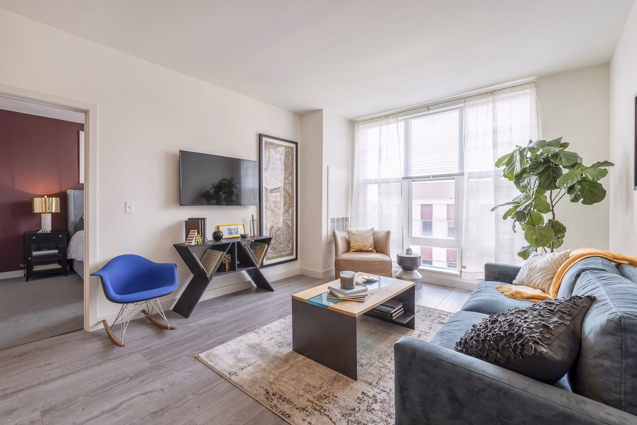 Modern living room with sleek furnishings and natural light at West of Chestnut Apartments