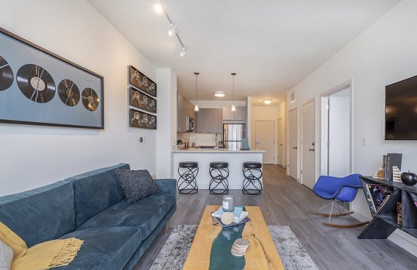 Elegant living room with contemporary design and large windows in West of Chestnut Apartments luxury property