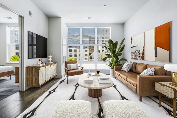 Spacious living room with modern design elements in West of Chestnut Apartments