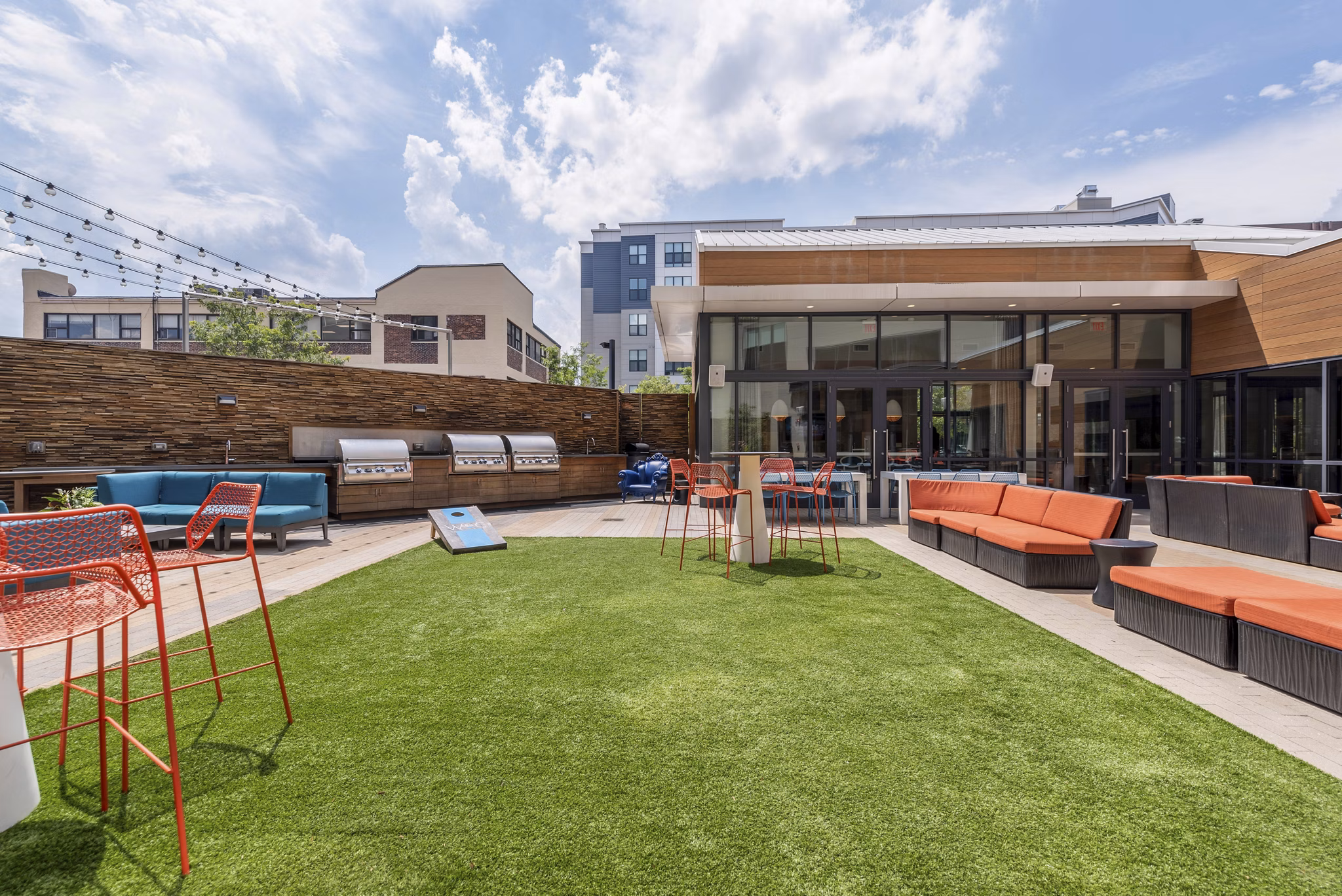 Outdoor courtyard with seating and greenery at West of Chestnut Apartments