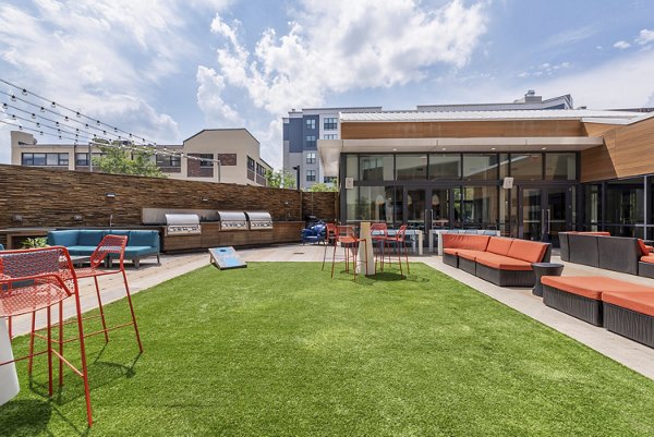 Outdoor courtyard with seating and greenery at West of Chestnut Apartments