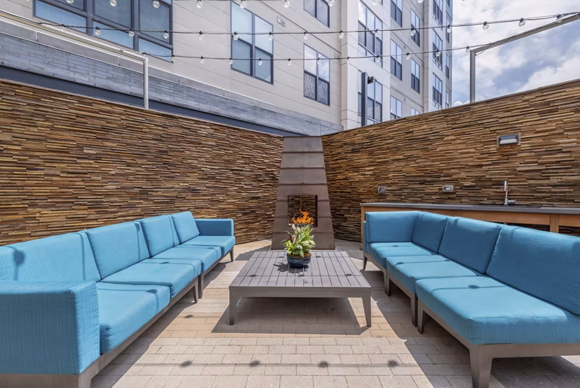 Outdoor fire pit area with cozy seating at West of Chestnut Apartments