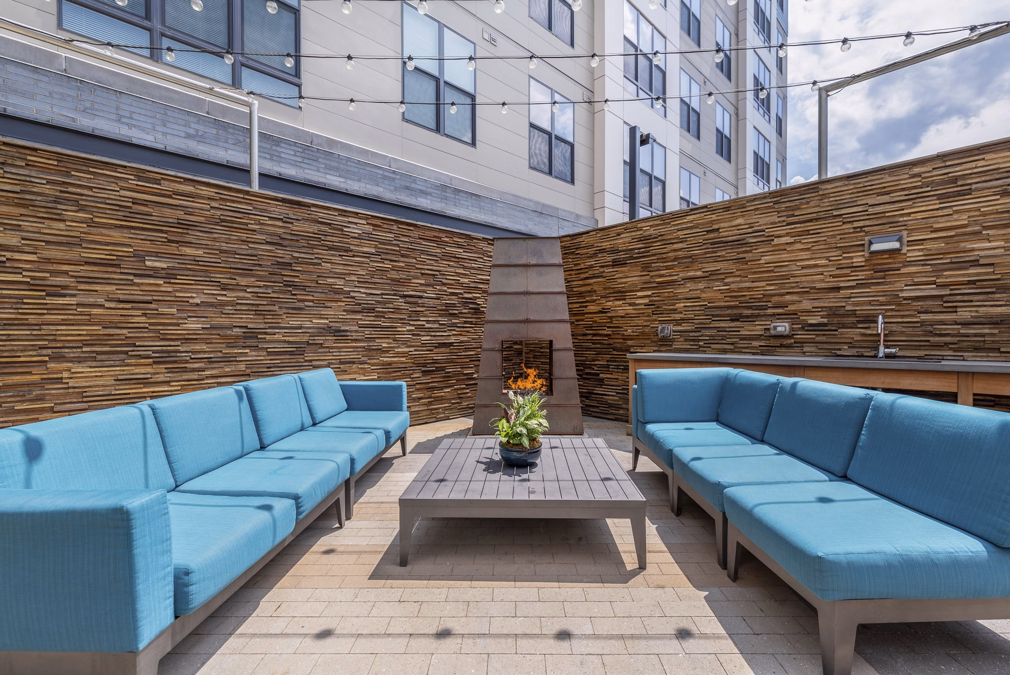 Outdoor fire pit area with cozy seating at West of Chestnut Apartments