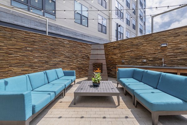 Outdoor fire pit area with cozy seating at West of Chestnut Apartments