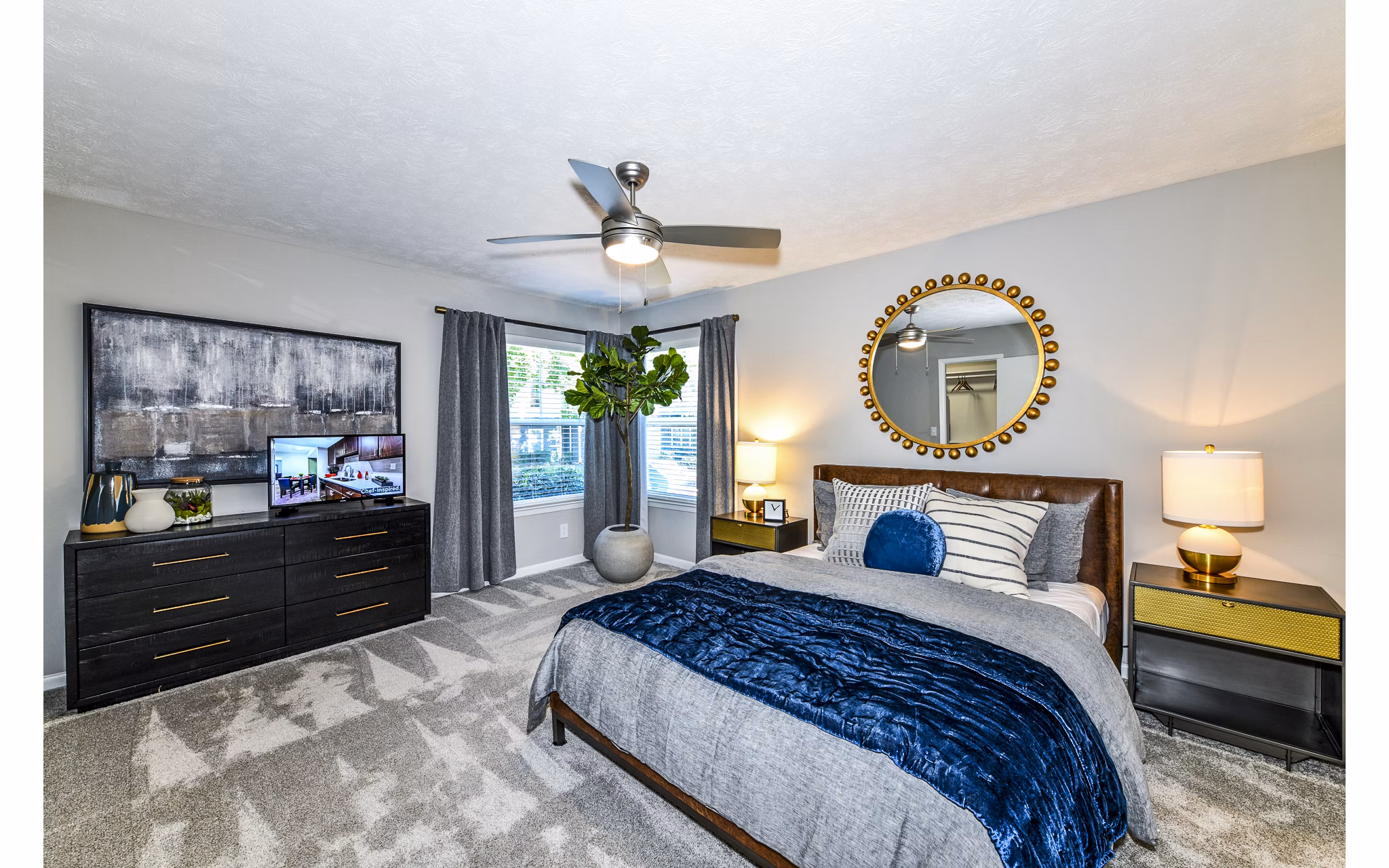 Avana Woods Apartments: Cozy bedroom with modern decor and large window for natural light