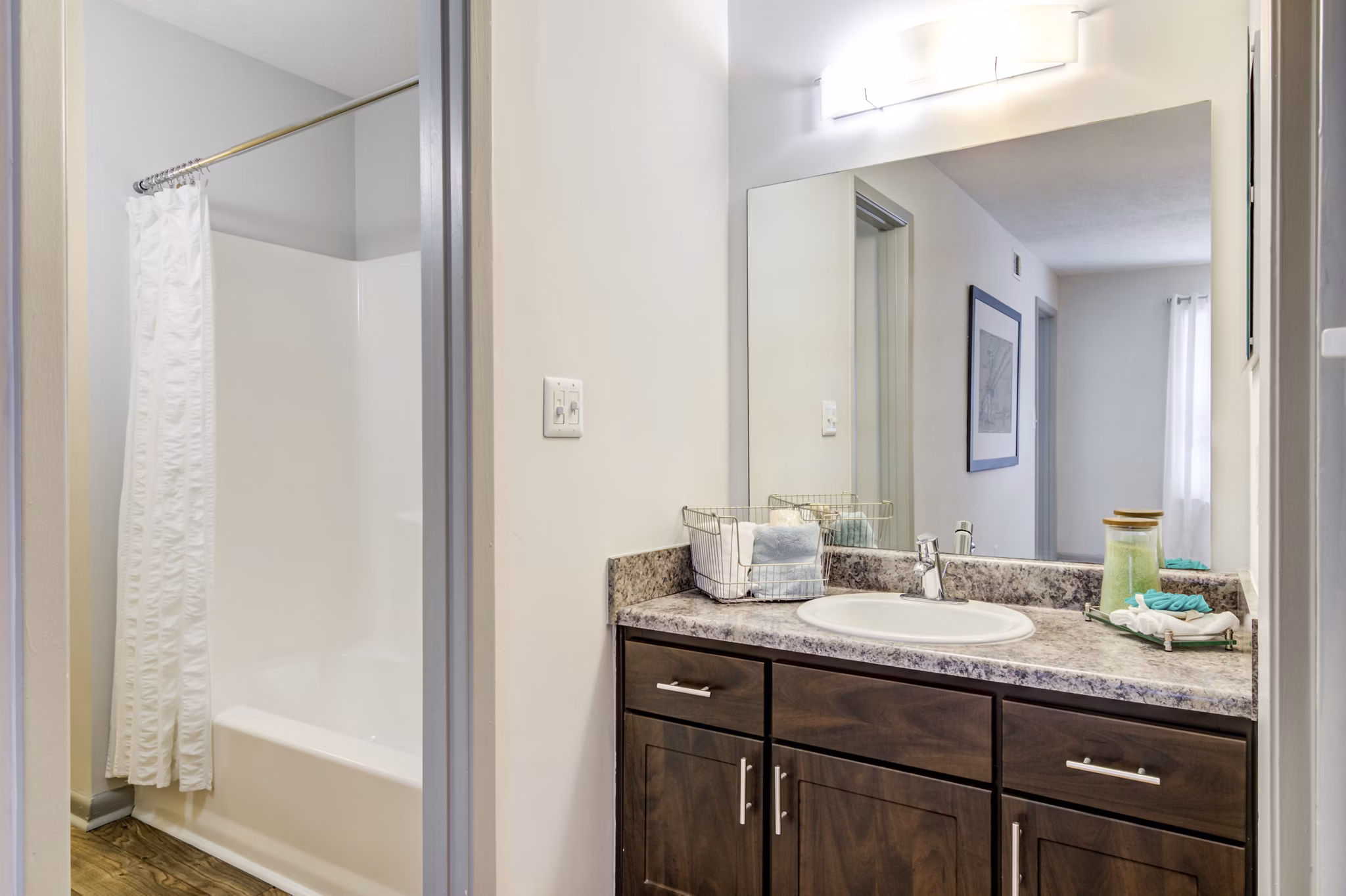 Modern bathroom with white cabinetry and sleek fixtures at Avana Woods Apartments