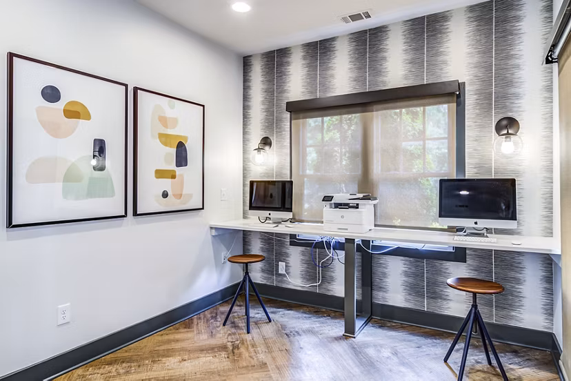 Modern business center with workstations at Avana Woods Apartments, ideal for remote work and meetings