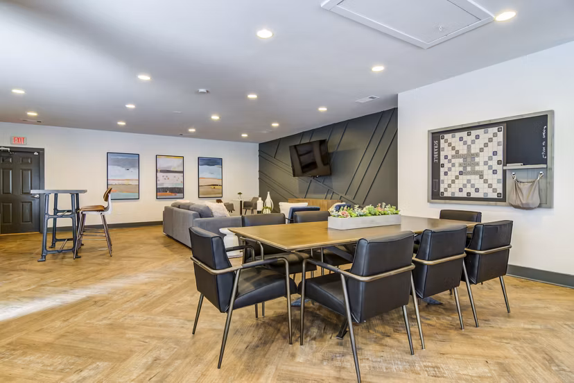 Clubhouse featuring modern design and cozy seating at Avana Woods Apartments