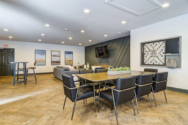 Clubhouse featuring modern design and cozy seating at Avana Woods Apartments