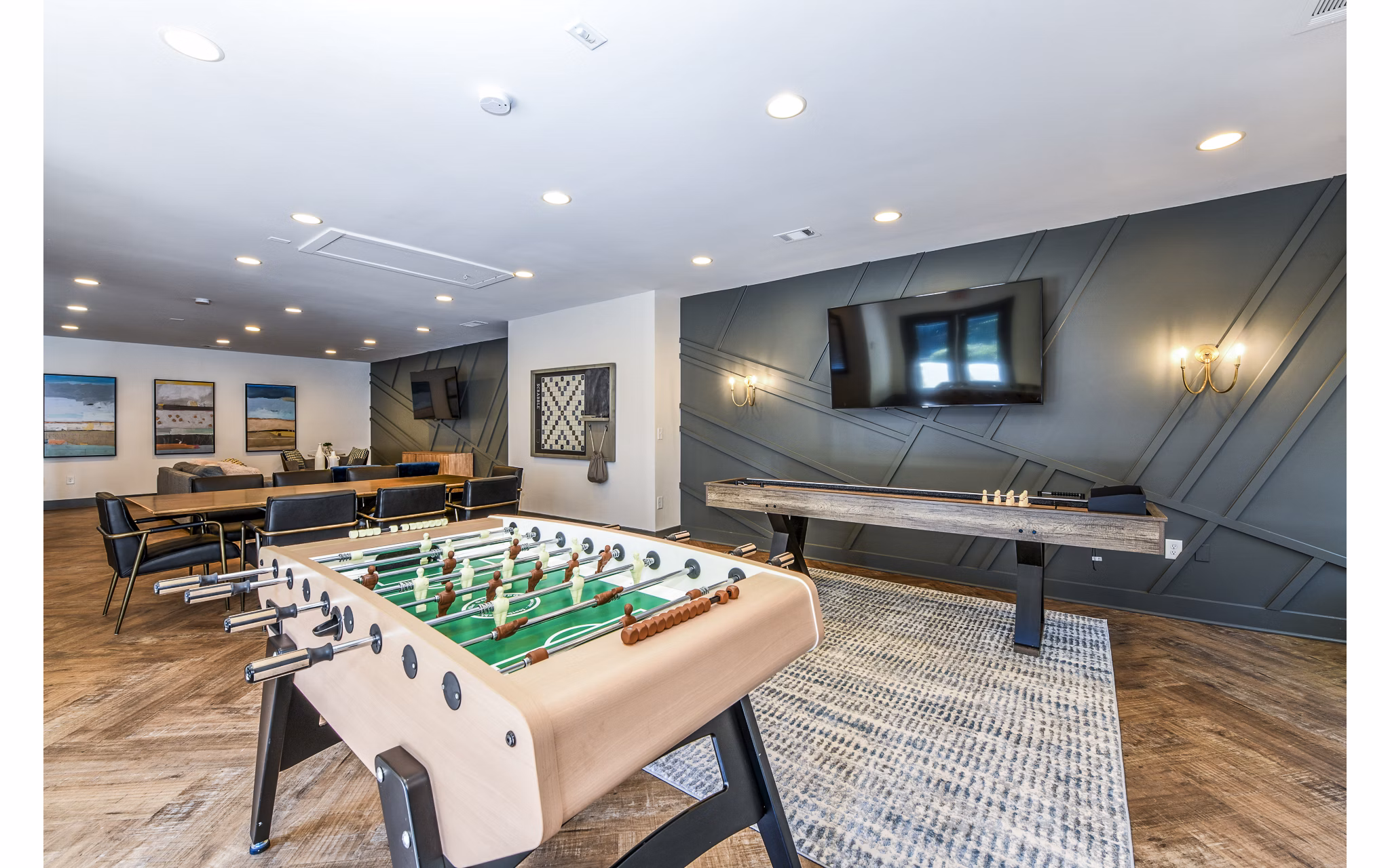Game room with pool table and lounge seating in Avana Woods Apartments for relaxation and entertainment