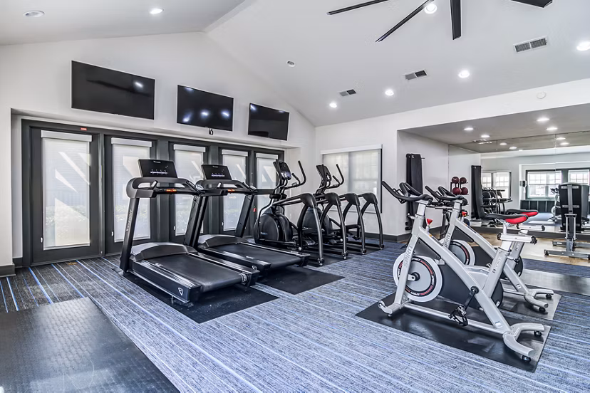 Modern fitness center with state-of-the-art equipment at Avana Woods Apartments