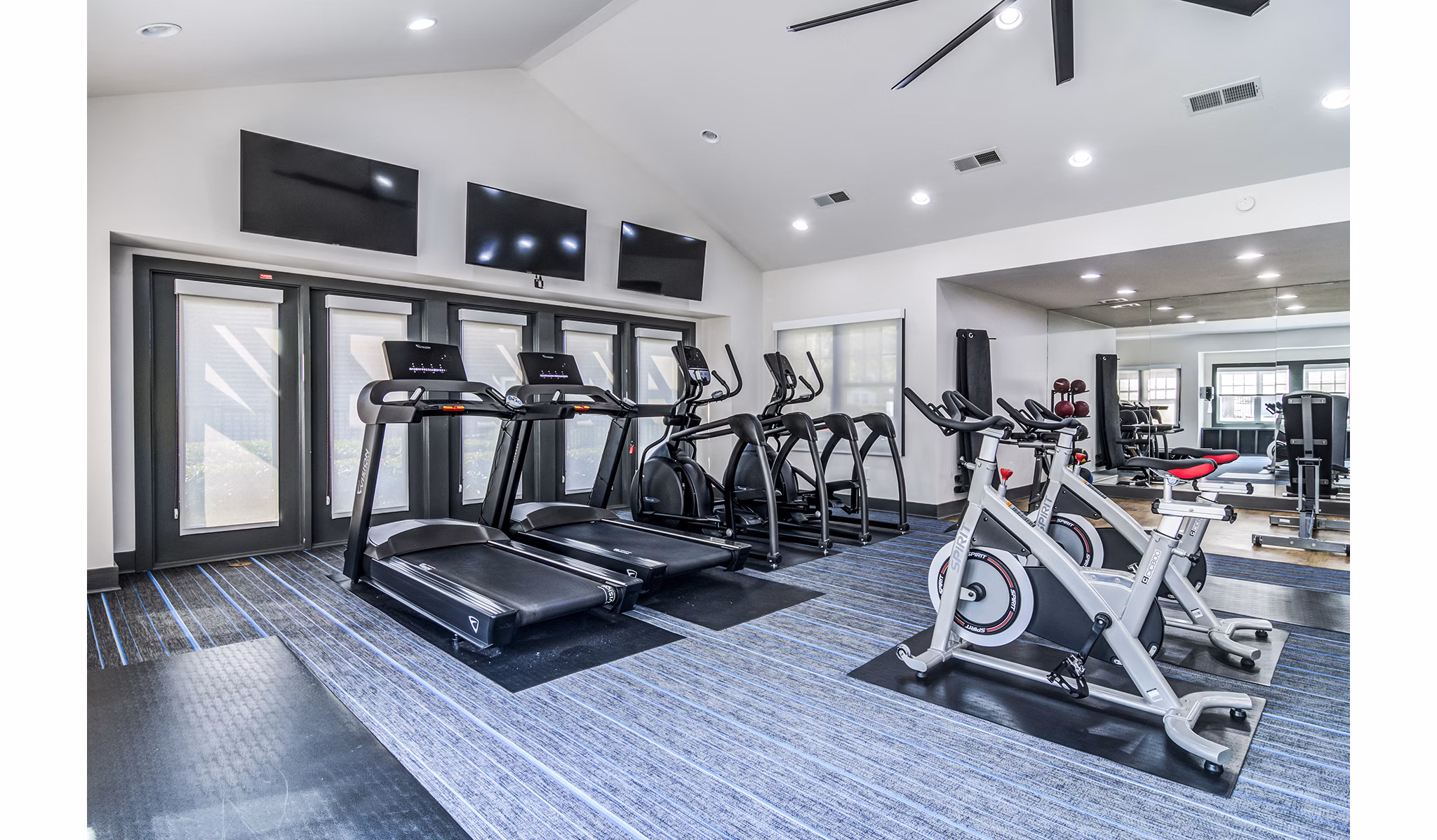 Modern fitness center with state-of-the-art equipment at Avana Woods Apartments