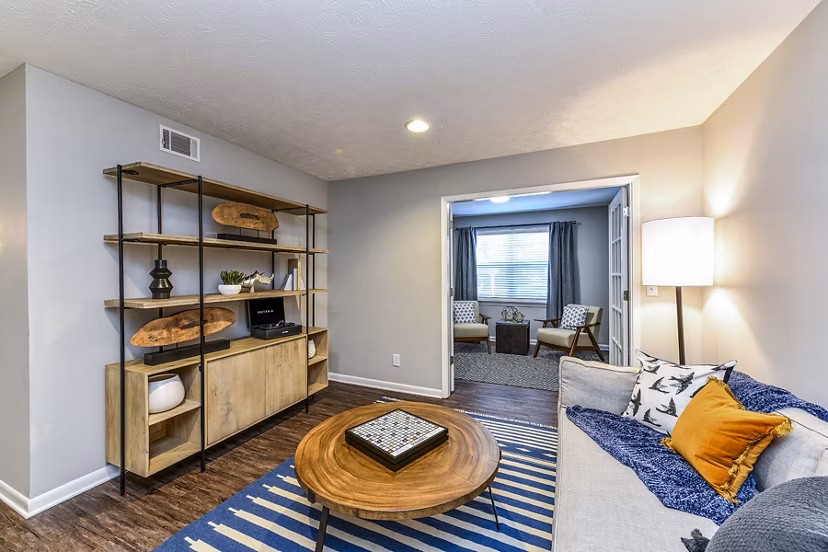Contemporary living room with cozy seating at Avana Woods Apartments, featuring elegant dÃ©cor and natural light