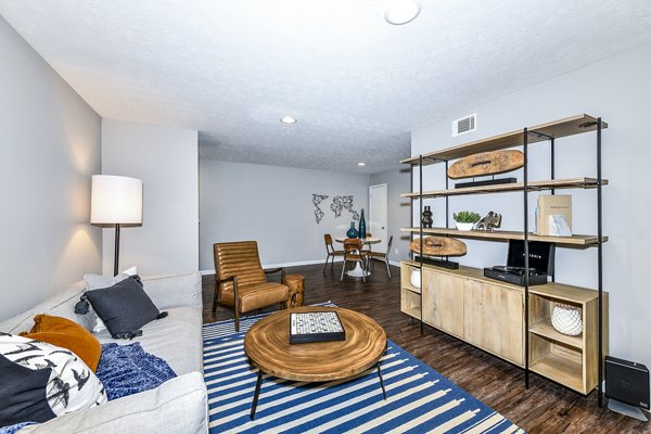 Living room featuring modern decor and natural light at Avana Woods Apartments, a Greystar property