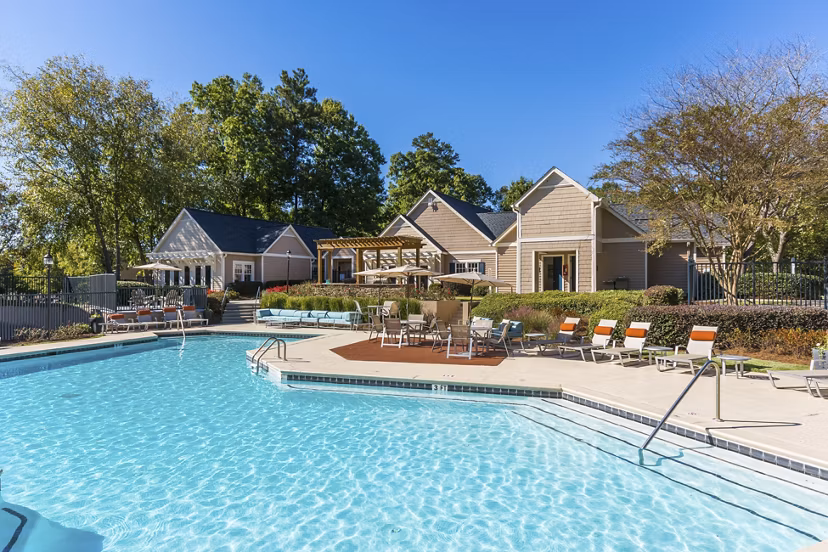 Resort-style pool area at Avana Woods luxury apartments surrounded by lush landscaping