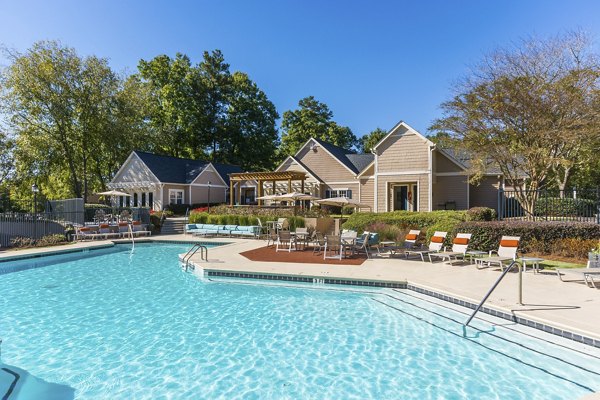 Resort-style pool area at Avana Woods luxury apartments surrounded by lush landscaping
