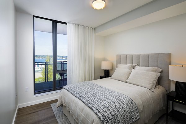 Modern bedroom with cozy queen bed and stylish dÃ©cor in Helm Apartments, offering luxury living spaces